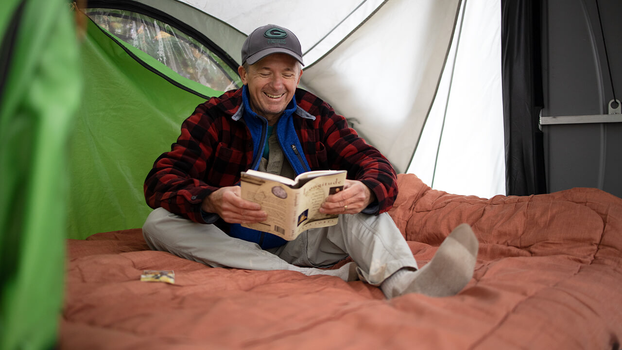 men reading inside GO Camper