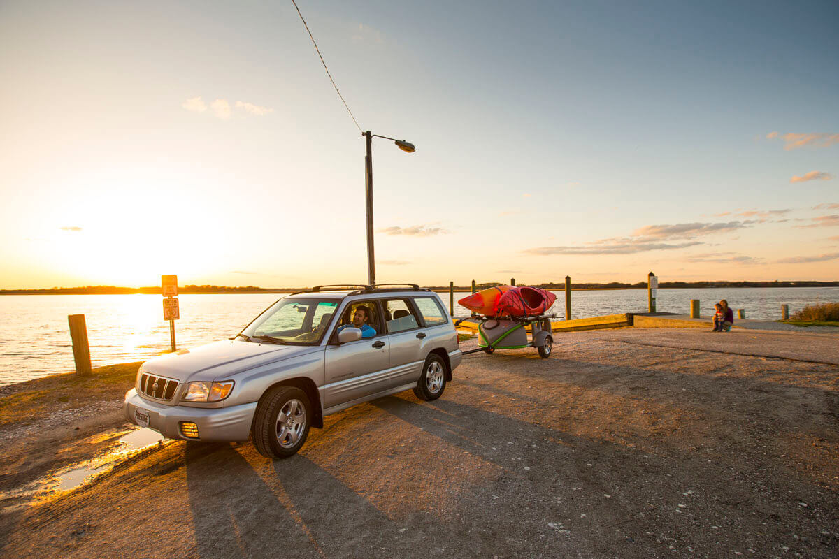 Car Towing Boat Trailer at Beach