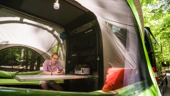 woman using cellphone inside GO Camper