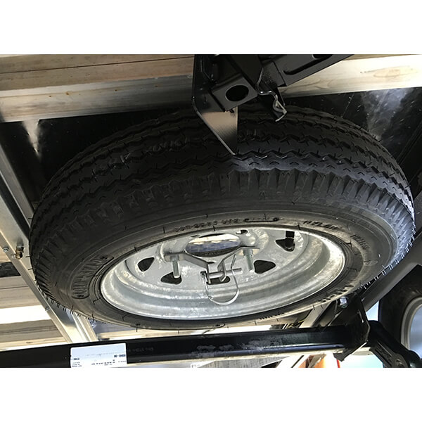 Spare tire below trailer view studio photo
