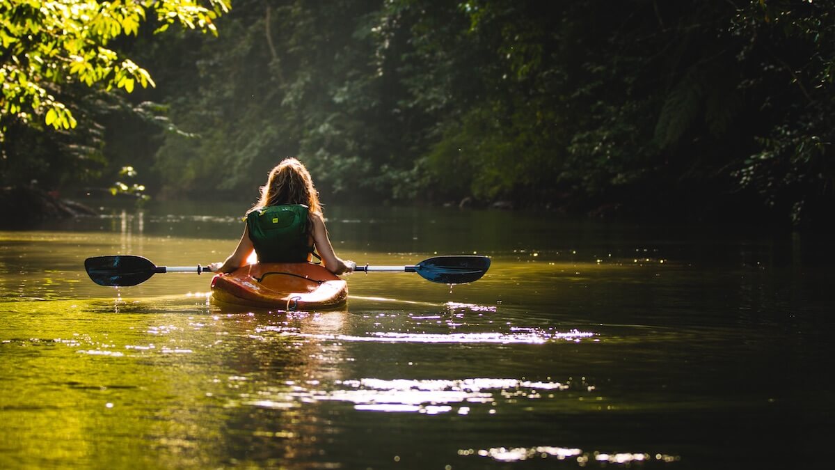 person inside kayak/river