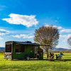 family sitting outside VAST Trailer