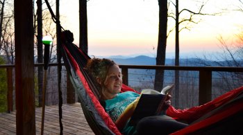 woman using WayLight Hiking Pole to read book