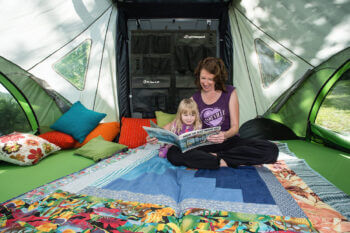 mom and kid reading inside GO Camper