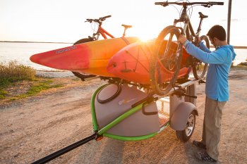 men unloading bike from kayak trailer