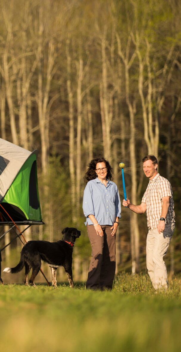 couple playing with dog