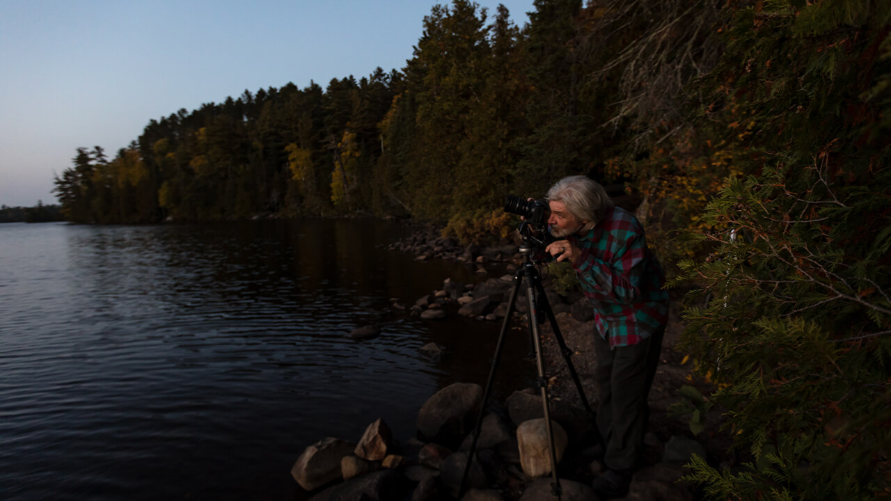 men taking pictures at dusk