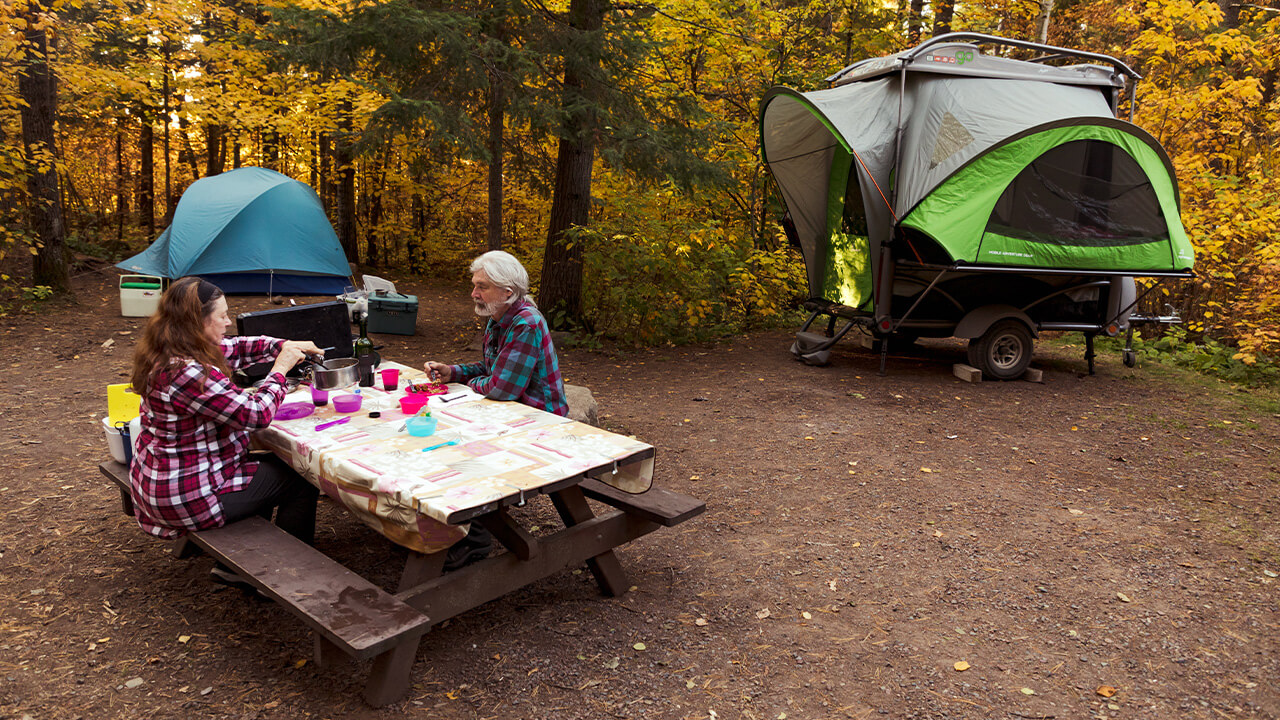 couple having breakfast outside their GO Camp trailer
