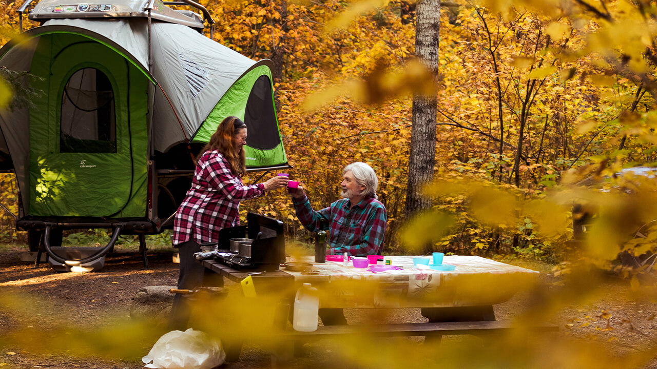 couple having breakfast outside their GO Camp trailer