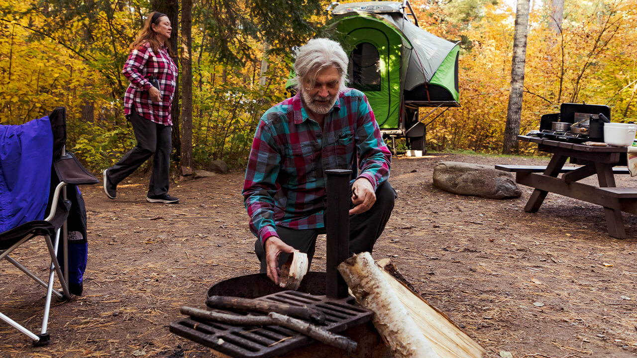 men setting a camp fire