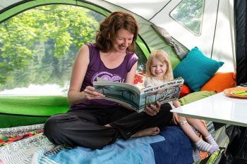 woman and kid reading Go Camper trailer