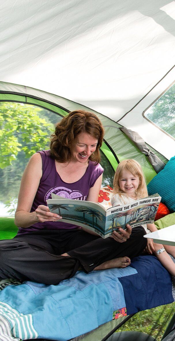 woman and kid reading Go Camper trailer