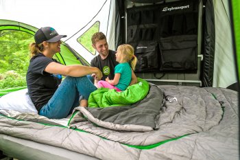 family inside GO Camping trailer with sleeping bags