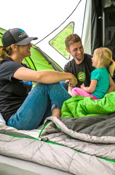family inside GO Camping trailer with sleeping bags