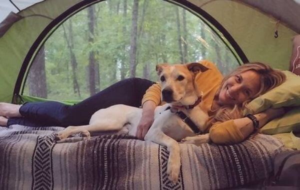 woman lying down with dog GO camping trailer