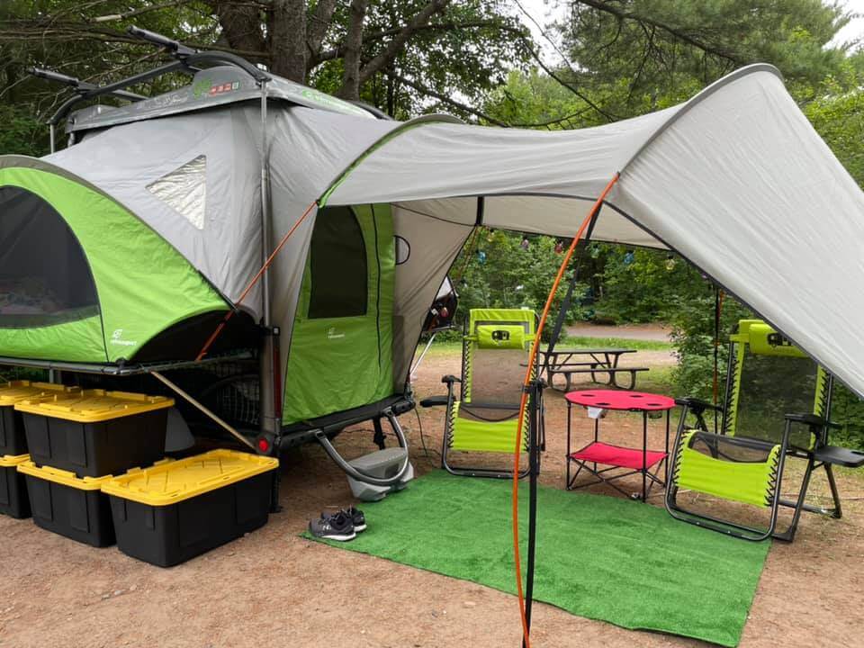 Go Camping Trailer with awning and some chairs