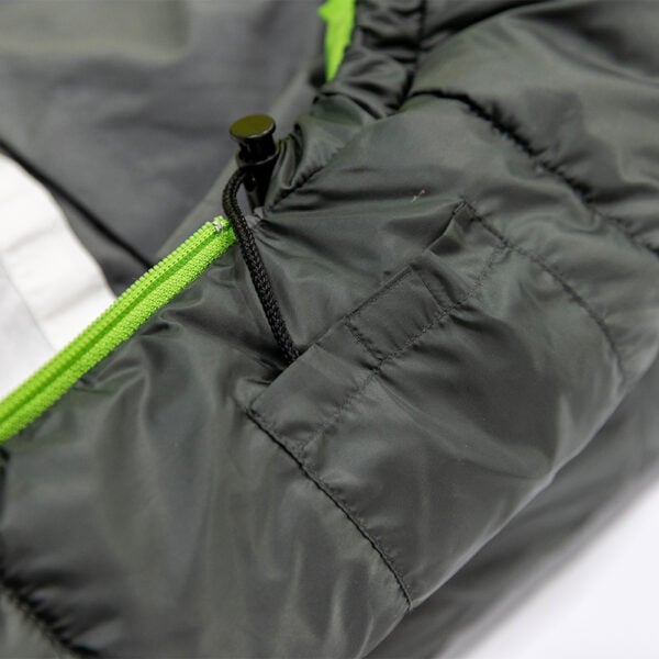 Close-up of Cloud Layer sleeping bag with green zipper and black drawstring.