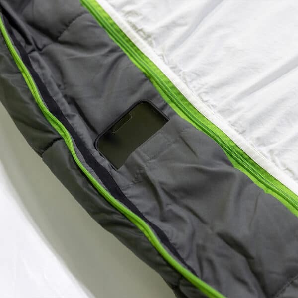 Sleeping bag with a smartphone pocket for outdoor adventures.