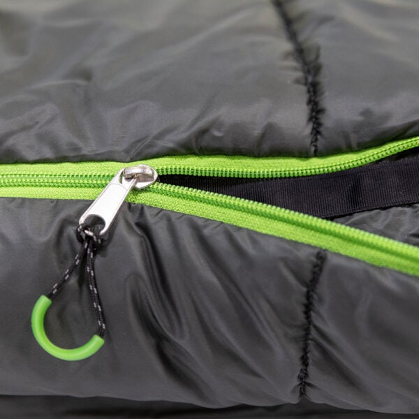 Close-up of a gray sleeping bag with green zipper and black pull tab.