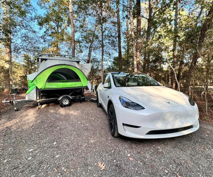 Tesla Model Y with GO Pop-Up Camper. Lightweight towable camper compatible with EVs.
