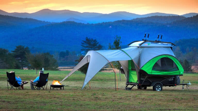 Portable GO camping trailer with tent extension for outdoor adventures.