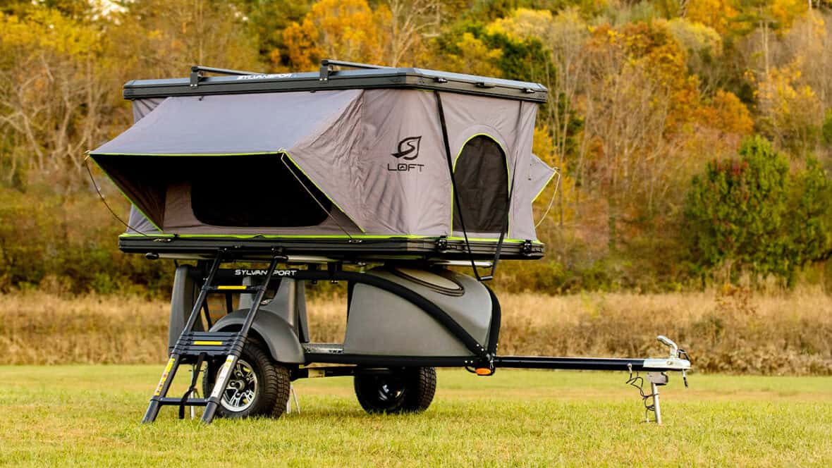 Micro Camper trailer with pop-up tent for camping and travel.