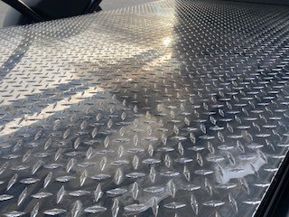 Durable diamond plate floor of the SylvanSport Optima trailer.