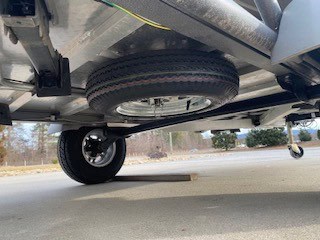 Optima trailer underside with spare tire and suspension system.