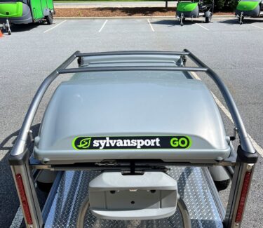 SylvanSport Optima trailer with cargo rack in parking lot.