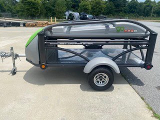 Compact SylvanSport trailer with black and green design for outdoor adventures.