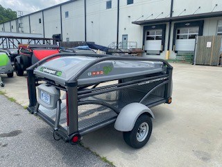 SylvanSport trailer with storage and camping gear in an industrial area.