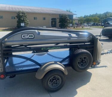 Compact SylvanSport GO camping trailer with storage and off-road tires.