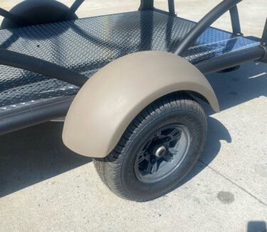 Compact SylvanSport Optima trailer with durable wheel and black metal frame.