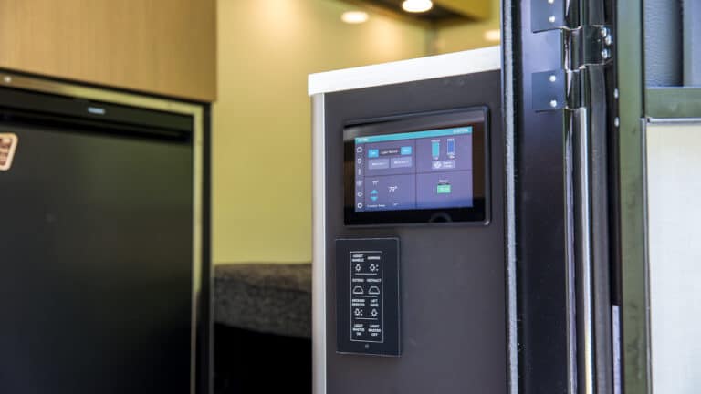 Close-up of SylvanSport VIRE travel trailer control panel and touchscreen display.