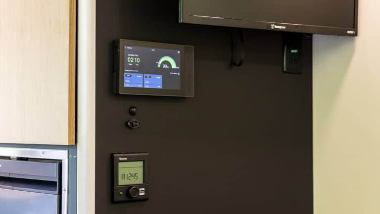 Interior control panel and digital thermostat in SylvanSport VIRE travel trailer.