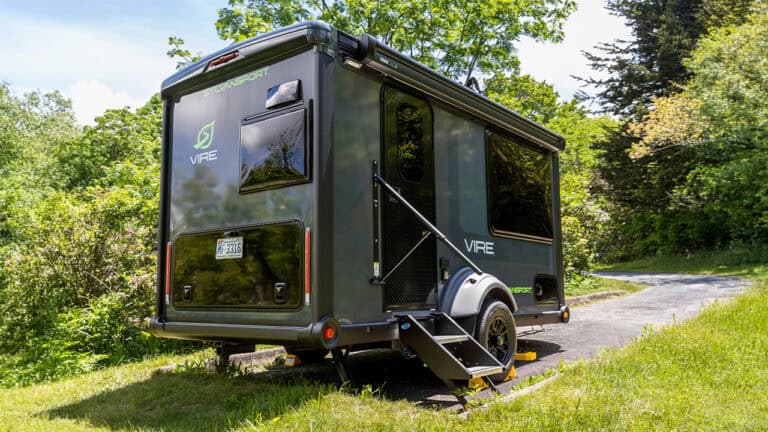 VIRE Travel Trailer by SylvanSport in a lush green outdoor setting.