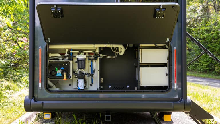 SylvanSport VIRE travel trailer with open rear hatch showing interior equipment.
