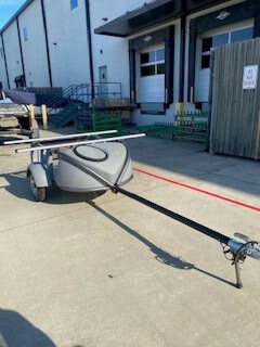 SylvanSport trailer parked outside a building, ready for outdoor adventures.