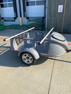 Compact SylvanSport trailer with roof racks for outdoor gear transport.