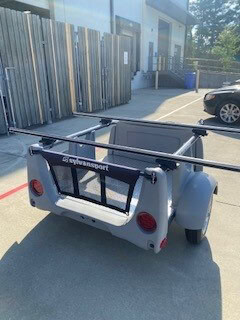 SylvanSport trailer with storage and camping gear for outdoor trips.