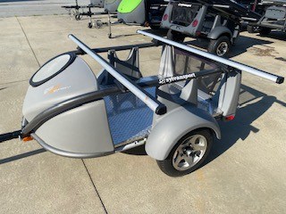 Compact SylvanSport trailer with roof racks for outdoor gear transport.