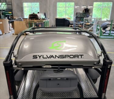 SylvanSport adventure trailer with storage and camping gear.