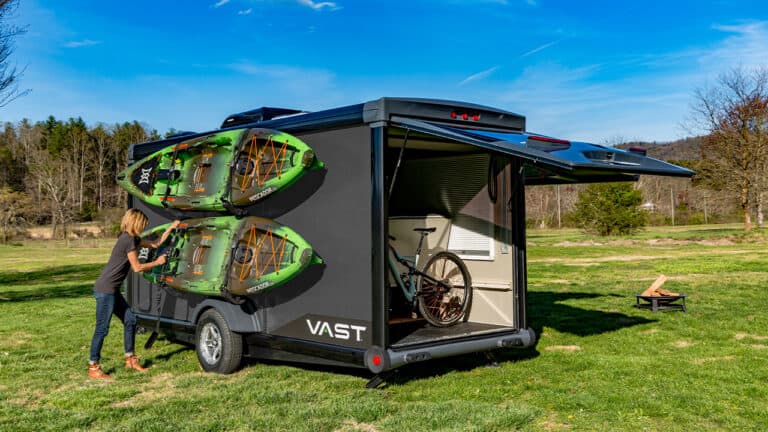 SylvanSport VAST outdoor camping trailer with kayaks and bike rack.