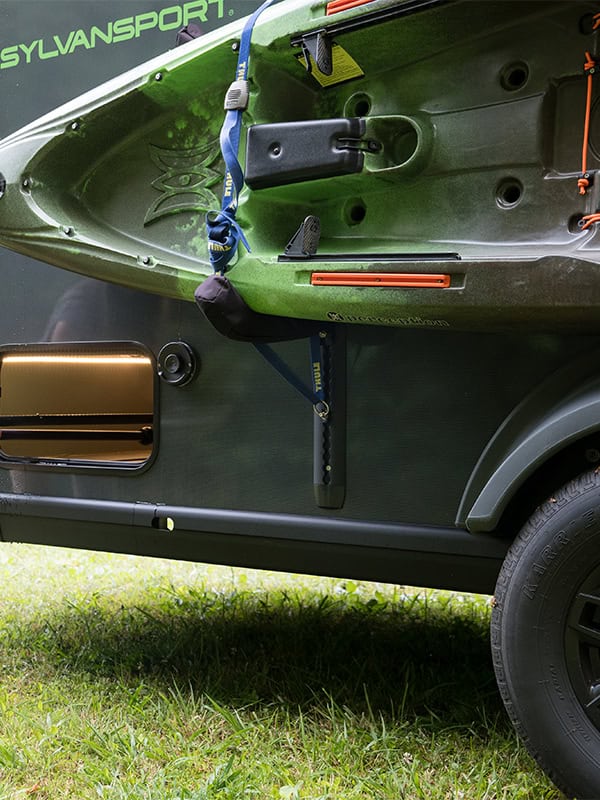 Green SylvanSport VIRE travel trailer with kayak and gear attached.