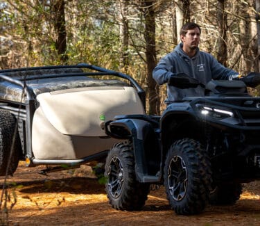 Optima ATV with cargo trailer for outdoor adventures and camping. Durable, versatile, perfect for ex.